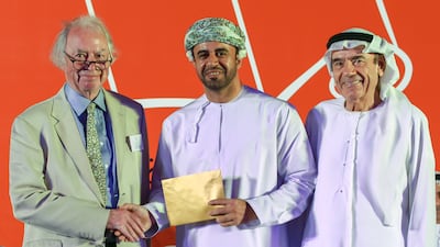 2023 International Prize for Arabic Fiction Awards winner Zahran Alqasmi, centre, with Jonathan Taylor, left and Zaki Nusseibeh, cultural adviser to the President of the UAE. Victor Besa / The National