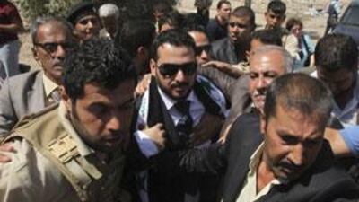 Muntadhar al Zeidi, centre, who threw his shoes at former President George W Bush, is released from a Baghdad prison.