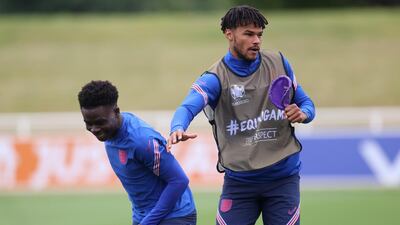 England's Tyrone Mings and Bukayo Saka during training. Reuters