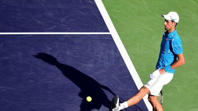 Novak Djokovic of Serbia kicks a tennis ball in a straight set win over Jo-Wilfried Tsonga of France during day twelve of the 2016 BNP Paribas Open at Indian Wells Tennis Garden on March 18, 2016 in Indian Wells, California. Harry How/Getty Images/AFP