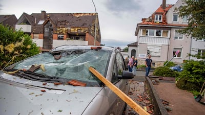 A roof batten is stuck in the windshield of a parked car in Paderborn, western Germany, following a tornado. AFP