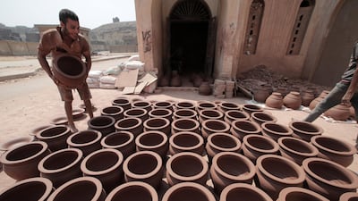 An Egyptian worker sorts clay pots to dry before displaying them for sale at one of the traditional pottery workshops in Old Cairo, Egypt. All photos: Khaled Elfiqi / EPA