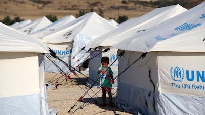 A migrant boy stands outside a tent at a refugee camp in Nea Kavala, northern Greece. About 1,500 asylum-seekers transported from Greece's eastern Aegean island of Lesbos to the mainland. Around 1,000 of those transferred and housed in Nea Kavala, where they will be staying in tents until the end of the month, after which they will be transferred to a new camp under construction. AP