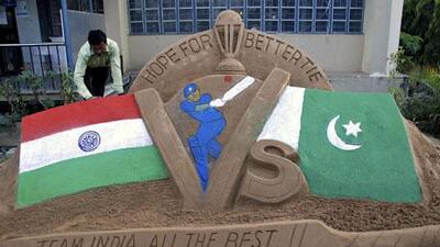 Indian artist Subala Moharana gives final touches to a sand sculpture on the eve of the India-Pakistan Cricket World Cup semi-final match in 2011
