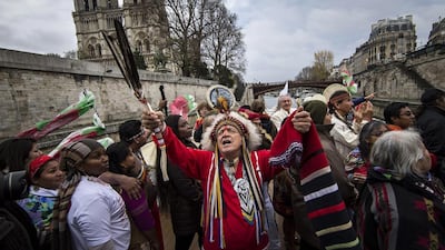 Indigenous representatives from around the world engage in a joint prayer session on board of a river boat on the Seine river, as part of a campaign to draw attention to the plight of indigenous tribes facing climate change on the sidelines of the COP21 Climate Conference, in Paris. EPA
