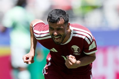 Boualem Khoukhi of Qatar celebrates his injury-time equaliser against Switzerland. AFP
