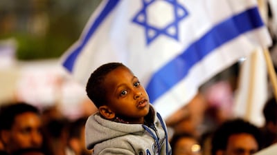 A boy takes part in a protest against the Israeli government's plan to deport African migrants in Tel Aviv. REUTERS/Corinna Kern/File Photo