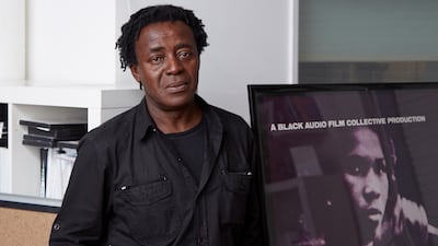John Akomfrah in his London studio with a poster for the film Handsworth Songs, made with the Black Audio Film Collective. Photo: British Council