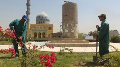Iraqi workers garden near the pedestal from which the statue of late Iraqi president Saddam Hussein was famously toppled in the garden of Firdos Square in Baghdad.
