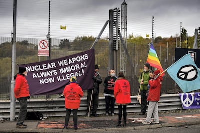 Anti-nuclear campaigners hold banners and placards outside Faslane naval base in Scotland. Getty.