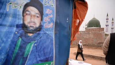 A portrait of Mumtaz Qadri, who was hanged last year for the murder of a governor who criticised Pakistan's blasphemy law, near a shrine to him that was built on the outskirts of Islamabad. Aamir Qureshi/AFP