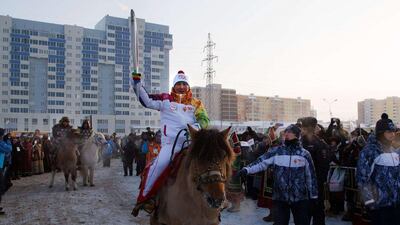 A torchbearer riding on horseback in Yakutsk, the capital of Sakha (Yakutia) Republic, about 4,830 km east of Moscow during the Sochi 2014 Winter Olympic torch relay. Sochi 2014 Organizing Committee / AFP Photo
