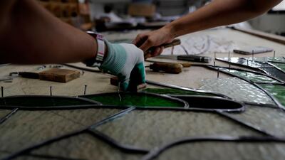 Artists work on the restoration of a piece damaged in the Beirut blast.