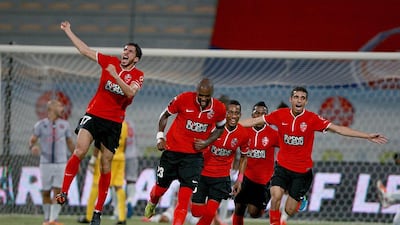A goal from Grafite, centre, ensures Al Ahli are 12 points ahead of Al Shaab. Satish Kumar / The National