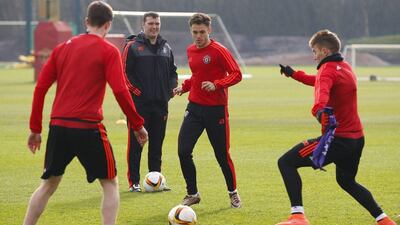 Manchester United's English defender Joe Riley (C) takes part in a team training session at their Carrington Training Centre in Manchester, north west England on February 24, 2016. The gloom that has been descending on Manchester United lifted a little when they beat Shrewsbury in the FA Cup on Monday, but manager Louis van Gaal remains a man facing problems. United's manager has no margin for error as he attempts to maintain his team's chances of a European trophy when they face Midtjylland at Old Trafford on Thursday. / AFP / LINDSEY PARNABY
