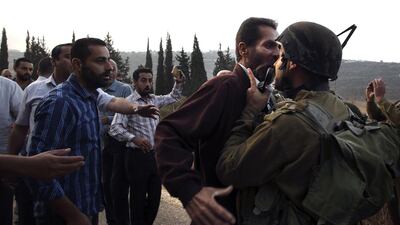 A Palestinian man scuffles with an Israeli soldier during clashes over an Israeli order to shut down a Palestinian school in the town of As Sawiyah, south of Nablus in the occupied West Bank. AFP