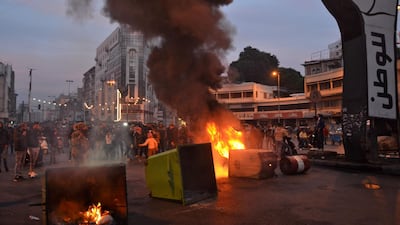 Lebanese anti-government protesters burn dumpsters to block al-Nour Square in Lebanon's northern port city of Tripoli. AFP