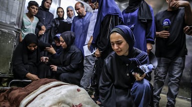 Relatives mourn for Firas Al Masri, his wife and their four children, who were killed in their sleep, in the morgue of Al Shifa Hospital in Gaza. EPA