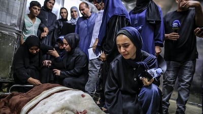 Relatives mourn for Firas Al Masri, his wife and their four children, who were killed in their sleep, in the morgue of Al Shifa Hospital in Gaza. EPA