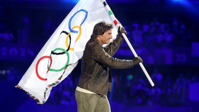 Actor Tom Cruise carries the Olympic flag during the closing ceremony of the Paris 2024 Summer Games. Reuters