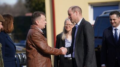 Prince William is greeted by Mr Blaszczak as he arrives for a visit to the base. Getty