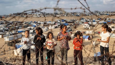 Children near a camp housing displaced Palestinians in Rafah last month. AFP