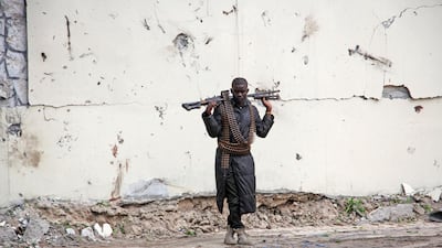 A Somali soldier stands at the scene of a suicide car bomb near the port in Mogadishu. AP Photo