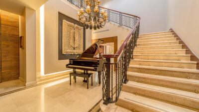 A grand piano sits in the hallway. Courtesy LuxuryProperty.com