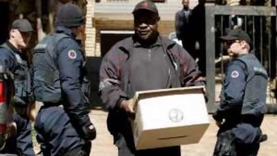 Members of the Directorate of Special Operations, or the Scorpions, leave the house of the ANC leader Jacob Zuma, who is facing corruption charges.