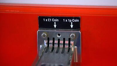 A children’s ride takes one-pound coins. The Royal Mint says the new 12-sided coins will make use of new security features already used in bills to keep criminals at bay. Bethany Clarke / Getty Images