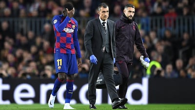 Barcelona's Ousmane Dembele limps off in the first half after picking up an injury. Getty