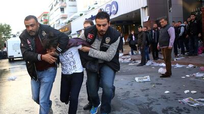 Police detain a youth at the headquarters of opposition television stations and newspapers in Istanbul on October 28, 2017. Mehmet Ali Poyraz, Cihan News Agency / AP Photo