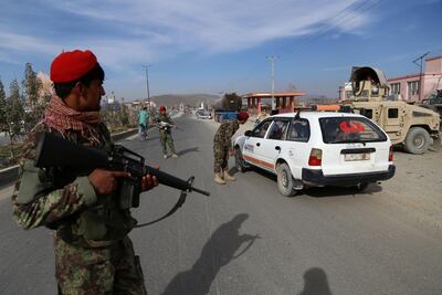 In this photo taken on October 29, 2018, Afghan security personnel search passengers in a checkpoint on Highway One in Ghazni. On a good day, it takes Mohammad less than three hours to drive from Ghazni to Kabul. But preparations for the hair-raising journey through Taliban-infested areas can take weeks. - TO GO WITH: Afghanistan-unrest-security, FEATURE by Allison JACKSON / AFP / ZAKERIA HASHIMI / TO GO WITH: Afghanistan-unrest-security, FEATURE by Allison JACKSON