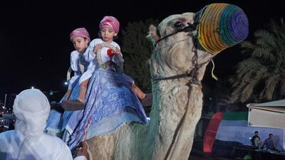 Children enjoy a camel ride during Tuesday’s National Day Carnival at Etihad Gallery, Abu Dhabi.