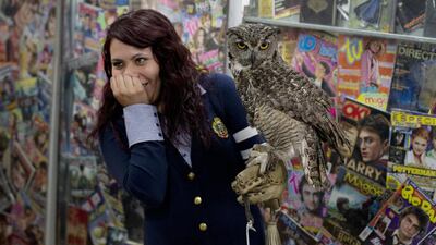 A Harry Potter fan reacts after a live owl bites her inside an exhibition of the Guinness World Record-holding collection of Harry Potter memorabilia, at the Mexican Museum of Antique Toys, in Mexico City, on February 27, 2015. Rebecca Blackwell/AP Photo