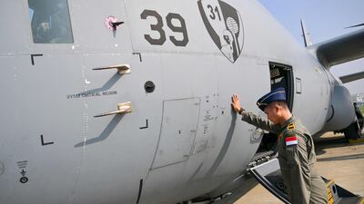 An Indonesian Air Force crew member prays before departing with humanitarian aid for Palestinians in Gaza, on board two Hercules C-130 aircraft, in Jakarta. AFP