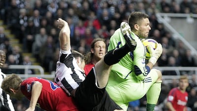 Newcastle United defender Mike Williamson vies with West Brom's Ben Foster. Graham Stuart/AFP