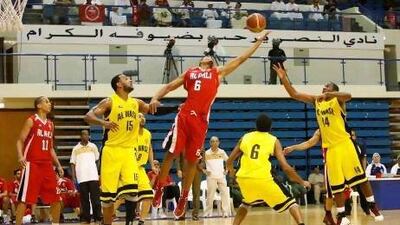 Al Ahli players celebrate with coach Peter Schomers after having swept all but one domestic trophies, including a sixth league title and a ninth President’s Cup.