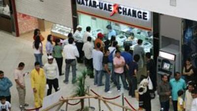 People line up at the Qatar-UAE money exchange at the City Centre-Doha mall in Doha, Qatar on March 28, 2008.