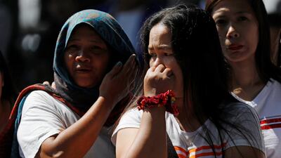 Onlookers react as rescuers attempt to reach survivors. Reuters