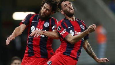 San Lorenzo's Fabricio Coloccini and Gonzalo Rodriguez of Palmeiras compete in a football match at Allianz Parque stadium in Sao Paulo, Brazil. Reuters