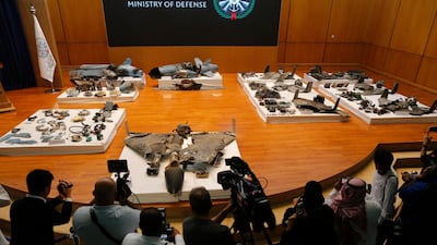 Journalists film what Saudi military spokesman Col. Turki al-Malki said was evidence of Iranian weaponry used in the attack targeted Saudi Aramco's facilities, during a press conference in Riyadh, Saudi Arabia, Wednesday, September 18, 2019. AP Photo