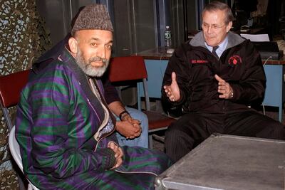 Former US Secretary of Defence Donald Rumsfeld, right, meets Hamid Karzai, the then new interim Prime Minister of Afghanistan at Bagram Airfield in Afghanistan, on December 16, 2001. AP