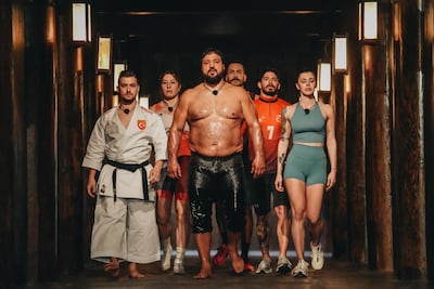 Oil wrestling champion Recep Kara, centre, leads Team Turkey. Photo: Netflix