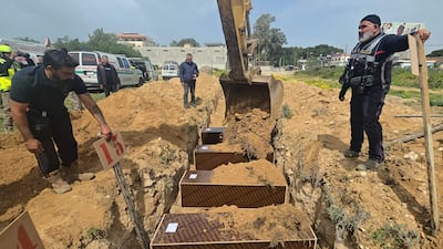 Volunteers bury people killed in overnight Israeli strikes at a temporary graveyard in the coastal Lebanese city of Tyre on Sunday. AFP