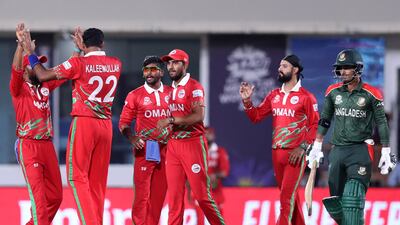 Oman's Kaleemullah celebrates with teammates after the dismissal of Bangladesh's Mahedi Hasan. AFP