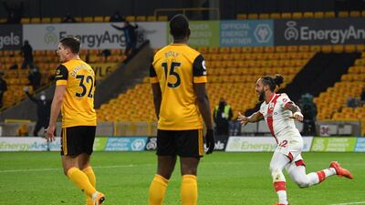 Theo Walcott begins his celebration after scoring the opening goal against Wolves. AFP