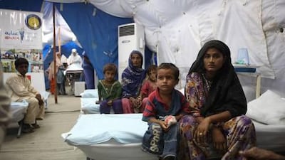 Children wait with their mothers to receive medical care at a UAE medical clinic in Thatta, Pakistan. The UAE has become the first non-western nation in the global Top 10 humanitarian aid donors per head of population.