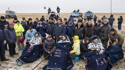 Russian cosmonauts Mikhail Kornienko, left, Sergey Volkov, and US astronaut Scott Kelly rest in chairs outside the Soyuz TMA-18M space capsule after landing in a remote area outside the town of Dzhezkazgan, Kazakhstan, on March 2, 2016. Bill Ingalls / Nasa via AP