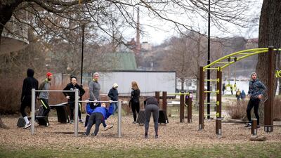 People exercise at an outdoor gym in a park in central Stockholm, Sweden, on April 1, 2020. Reuters